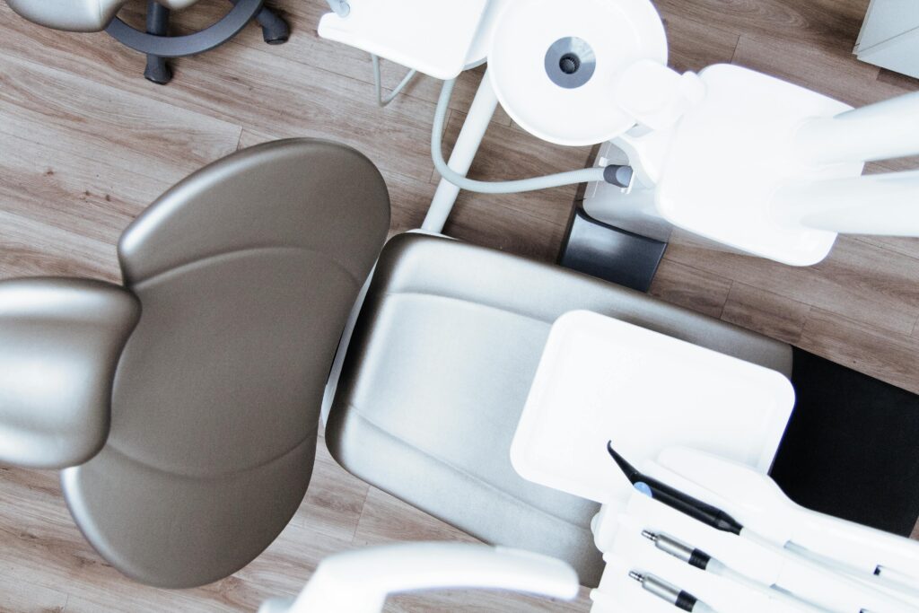 pexels-photo-305564-305564 High-angle view of a modern dental chair and equipment setup in a professional clinic.