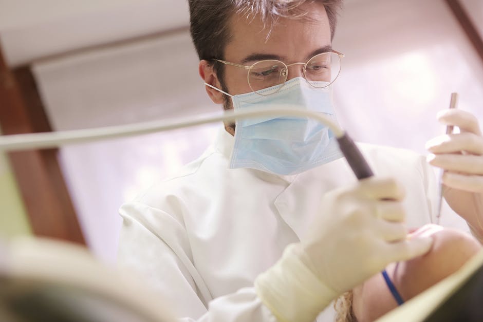 pexels-photo-3779697-3779697 Close-up of a dentist performing a dental procedure on a patient using modern tools.